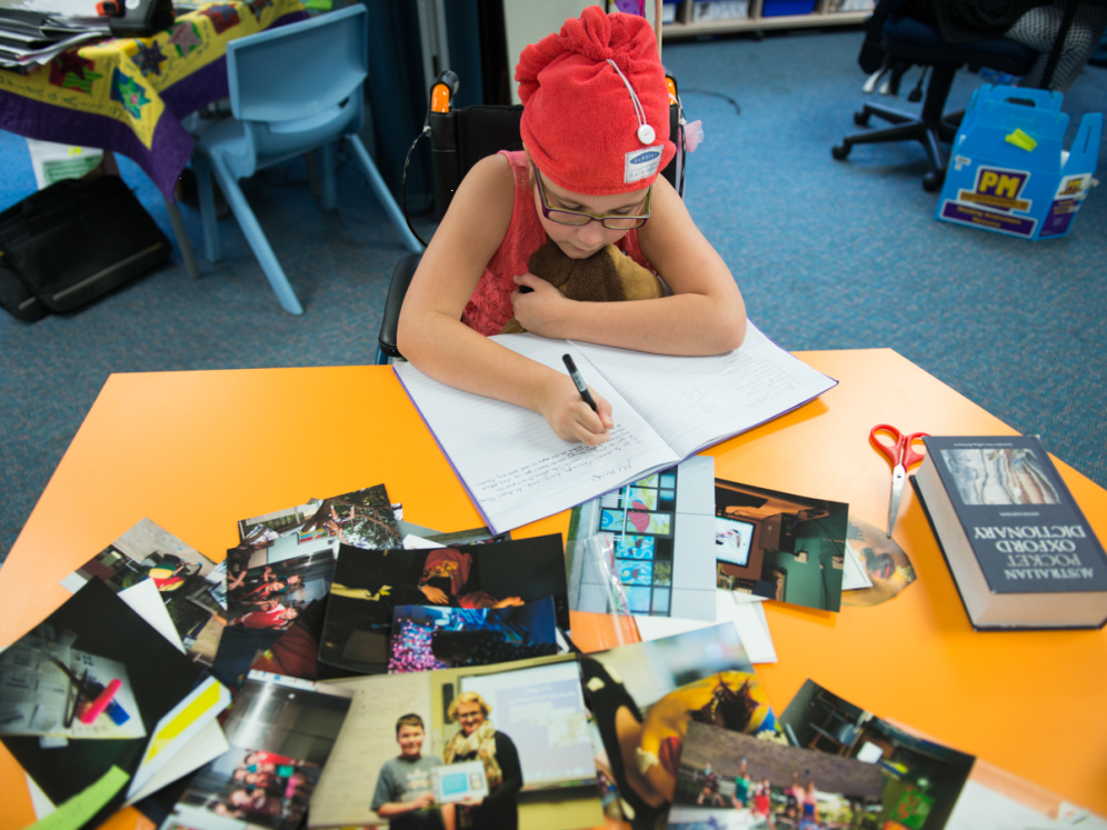 Girl at desk with photos